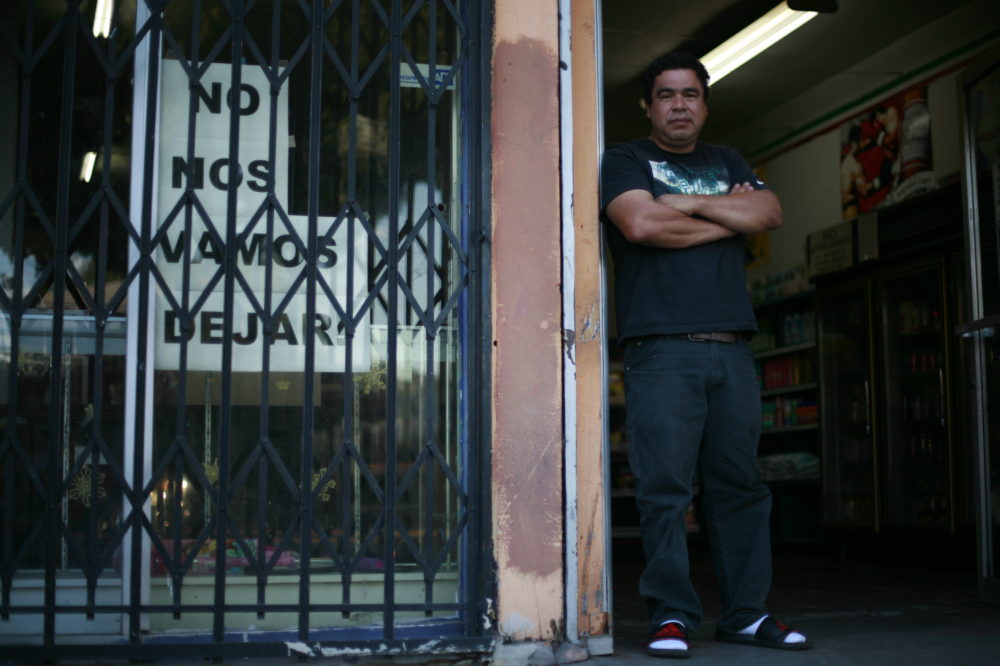 Miguel Ramirez, co-owner of the first-floor OK Market (also known as Edy's Market) in the Hollins building in Boyle Heights, says he and his sister Maria are determined to fight to keep their store. New building owner, Brian Neman, has raised their rent and other tenants in the building. Photo by Luis Rivas