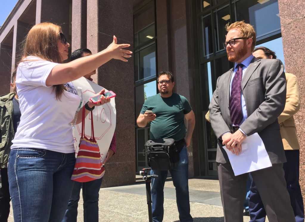 Tenant's rights groups march to the steps of the Los Angeles County Board of Supervisors' offices. Supervisor Hilda Solis' housing adviser, Russell Horning, came out to talk with them. JOSIE HUANG/KPCC