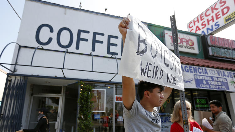 Opponents of Weird Wave Coffee in Boyle Heights demonstrate along East Cesar Chavez Avenue in June. (Gary Coronado / Los Angeles Times)