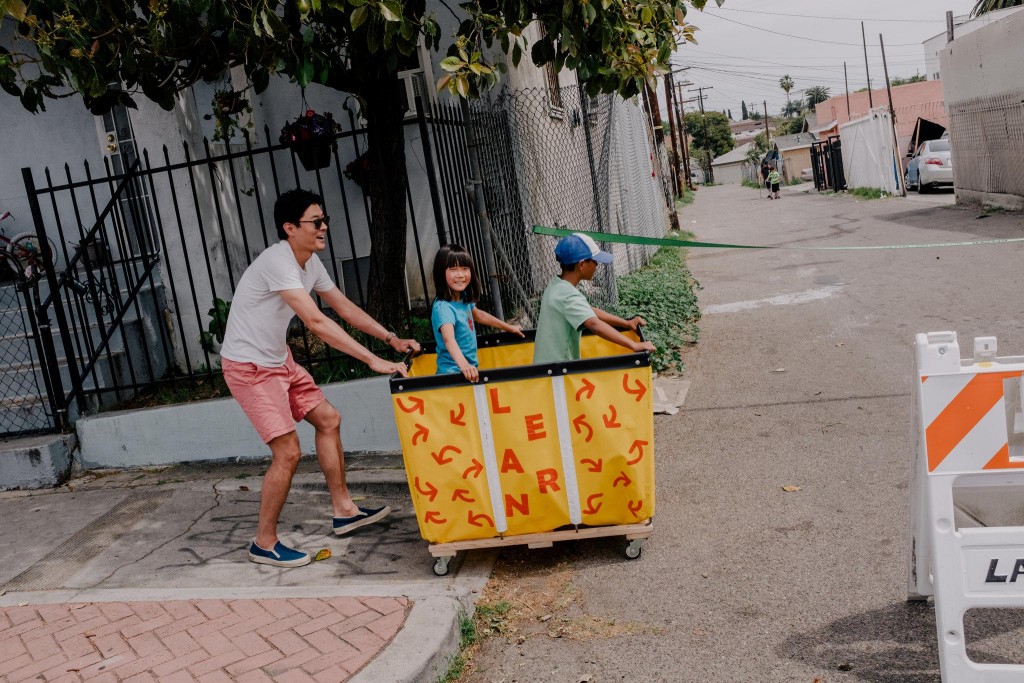 Children take a ride during a play streets event earlier this month.CreditColey Brown for The New York Times